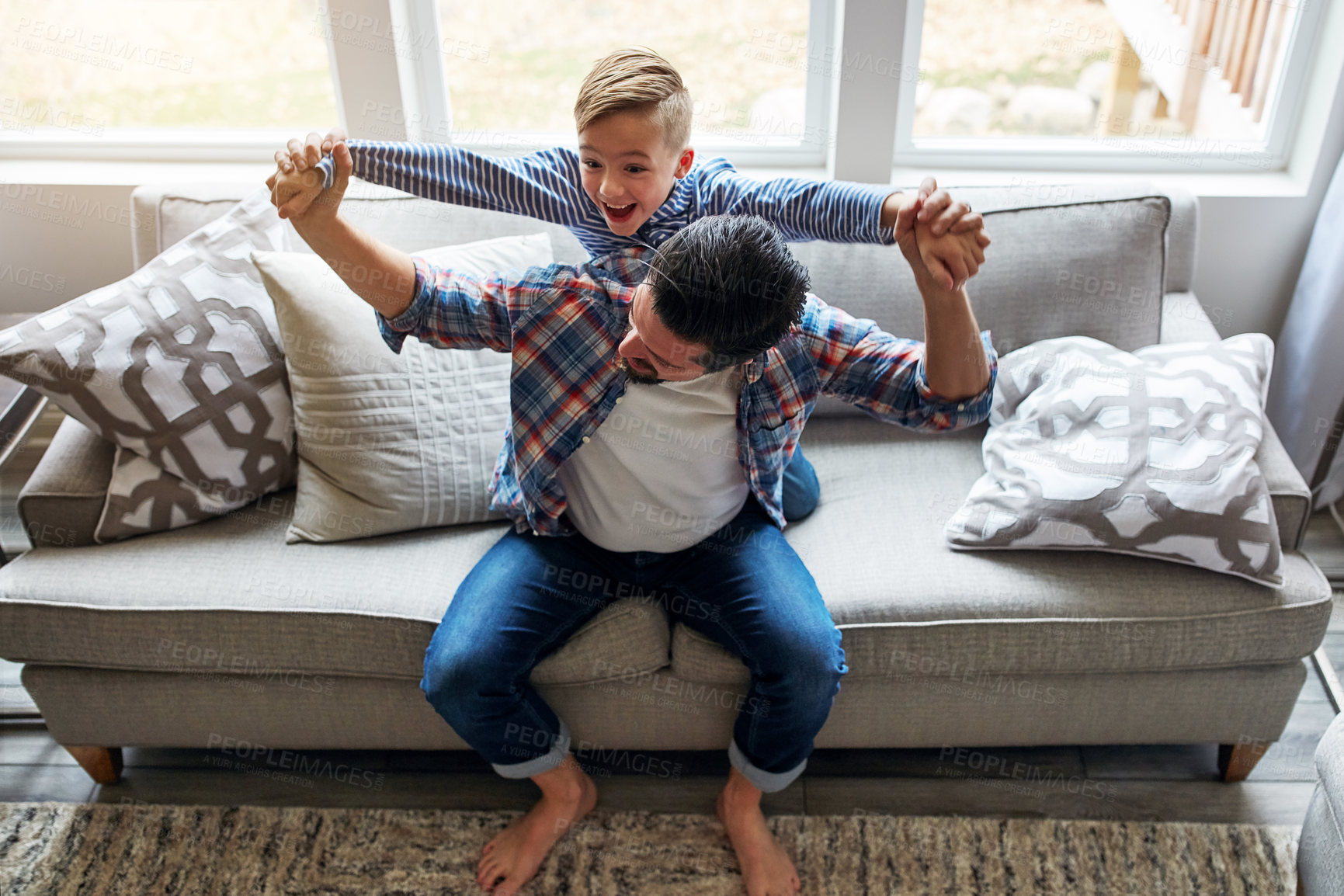 Buy stock photo Shot of a father and his little son bonding together at home