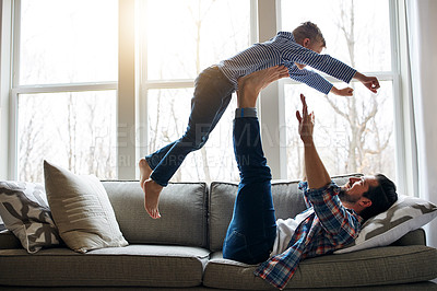 Buy stock photo Dad, son and support on sofa with fly for bonding, dream for superhero energy or childhood fantasy. Father, boy child and legs for airplane game or pilot in house, relax with flight in family home