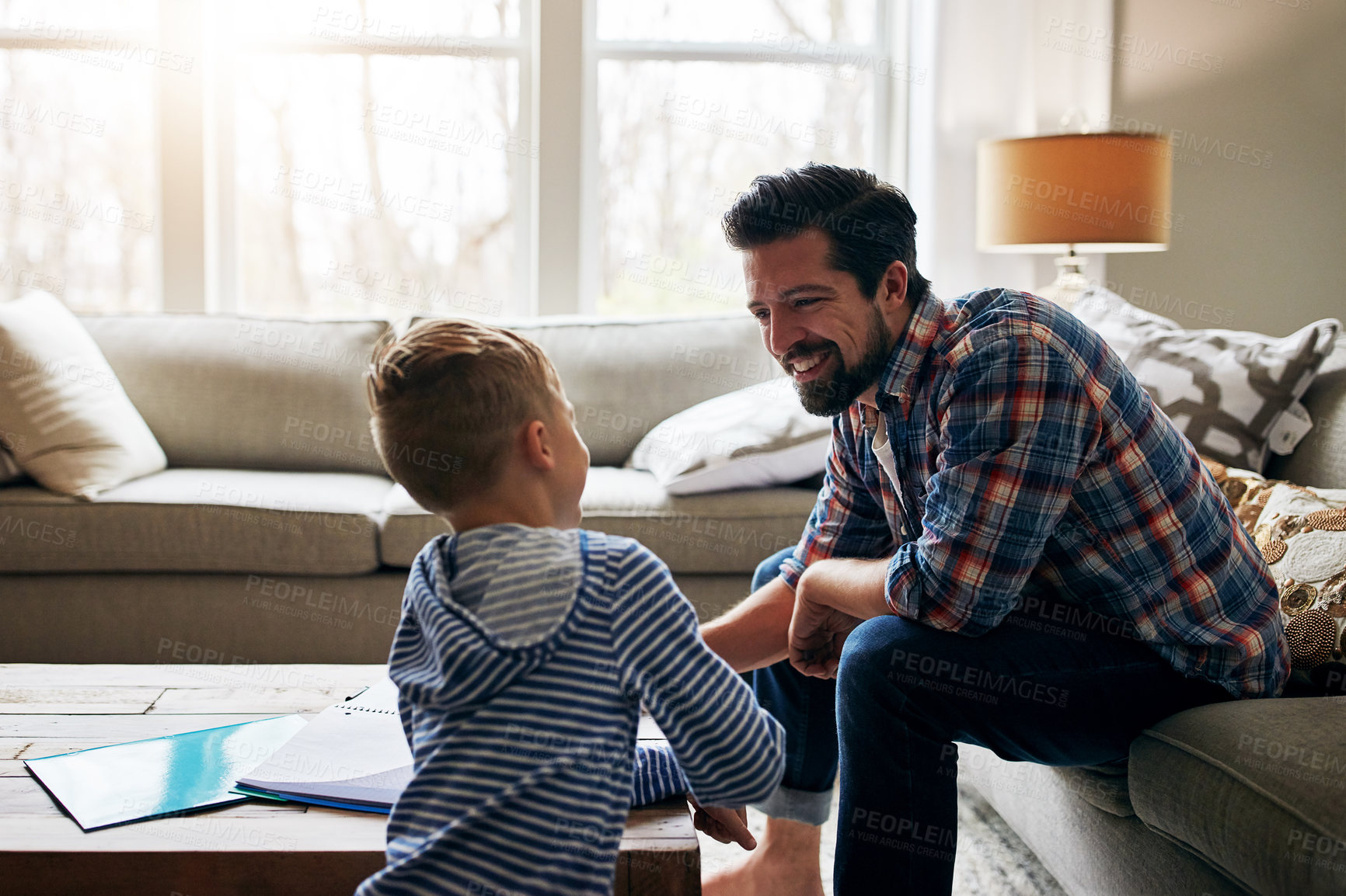 Buy stock photo Shot of a father helping his little son with his homework