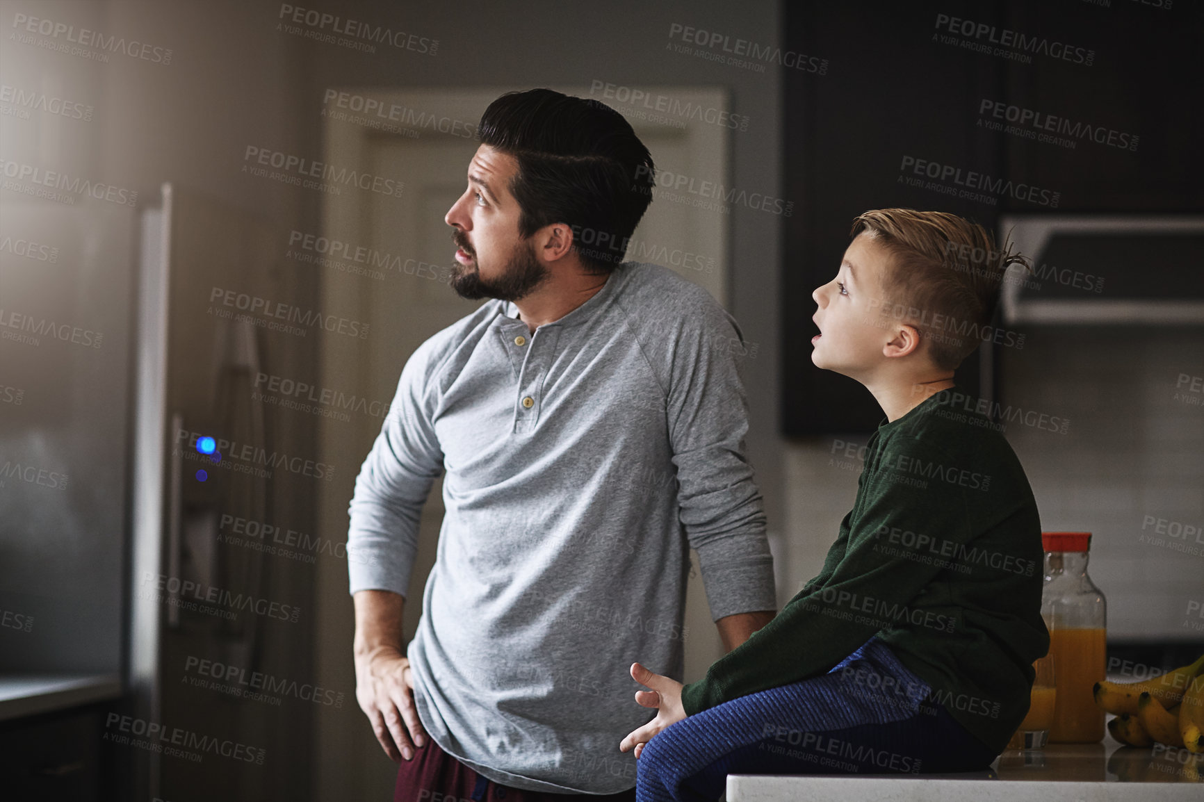 Buy stock photo Cropped shot of a handsome young man and his son in the kitchen at home
