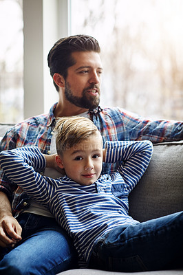 Buy stock photo Shot of a father and his little son bonding together at home