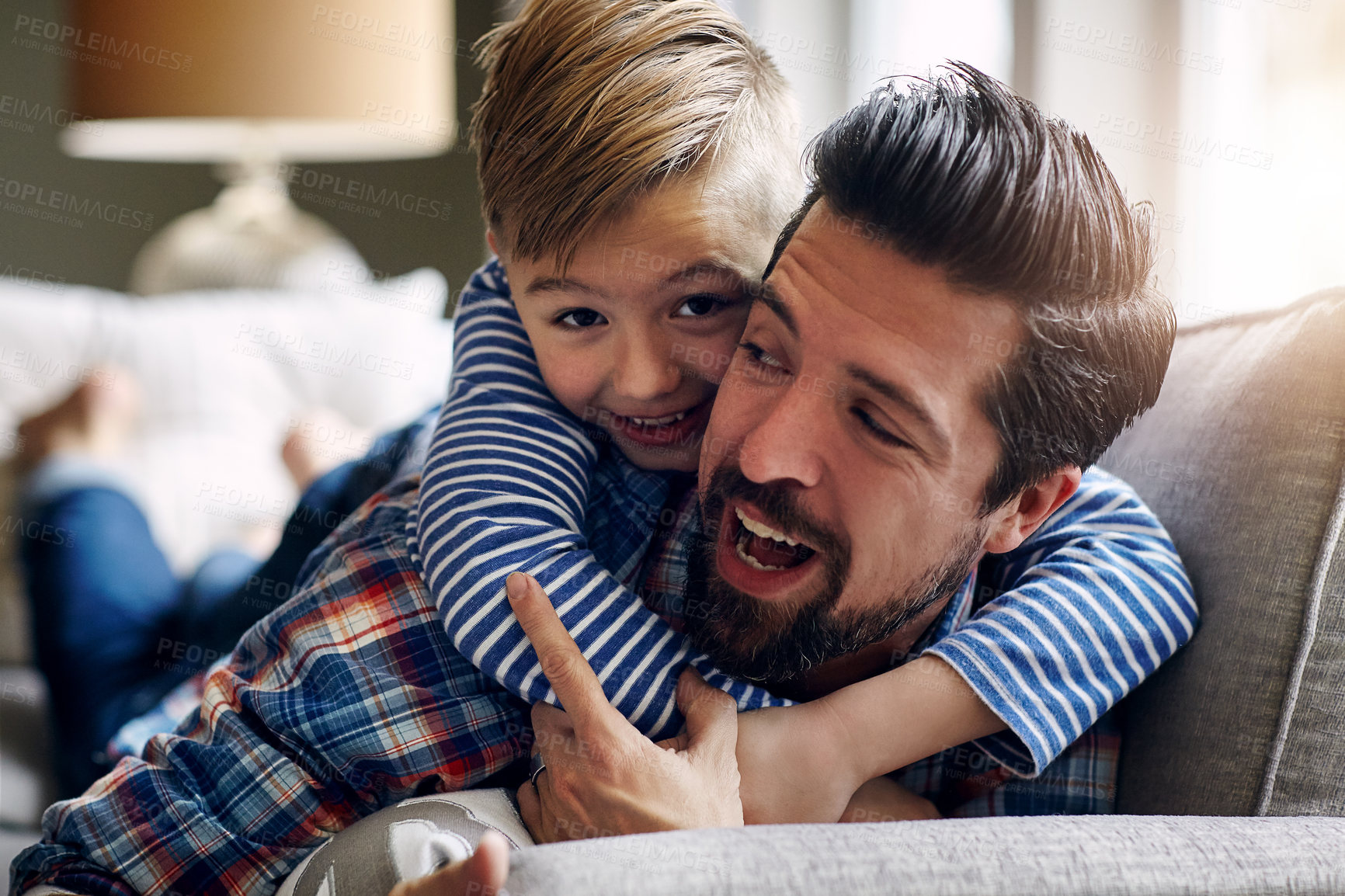 Buy stock photo Shot of a father and his little son bonding together at home