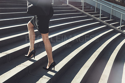 Buy stock photo Cropped shot of a businesswoman walking up urban steps