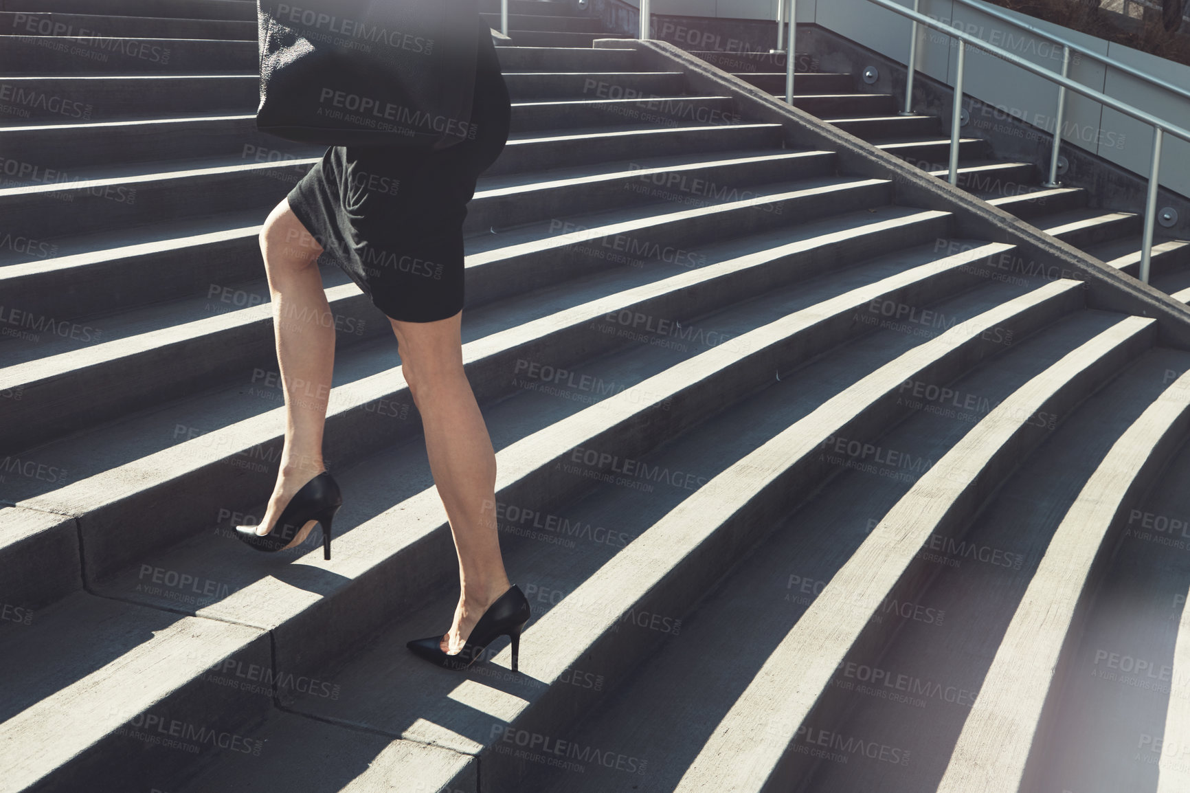 Buy stock photo Cropped shot of a businesswoman walking up urban steps
