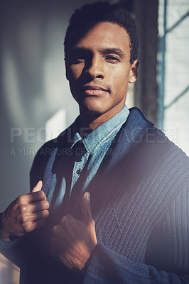 Buy stock photo Shot of a handsome young businessman standing in a modern office