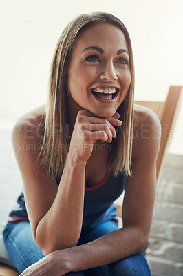 Buy stock photo Cropped shot of an attractive young sportswoman looking thoughtful while sitting on a wooden chair