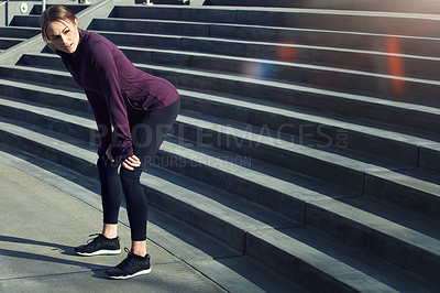 Buy stock photo Full length shot of an attractive young sportswoman looking thoughtful while resting after running up and down stairs outside