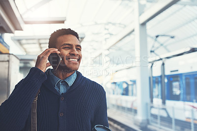 Buy stock photo Shot of a young businessman using a mobile phone while walking through the subway