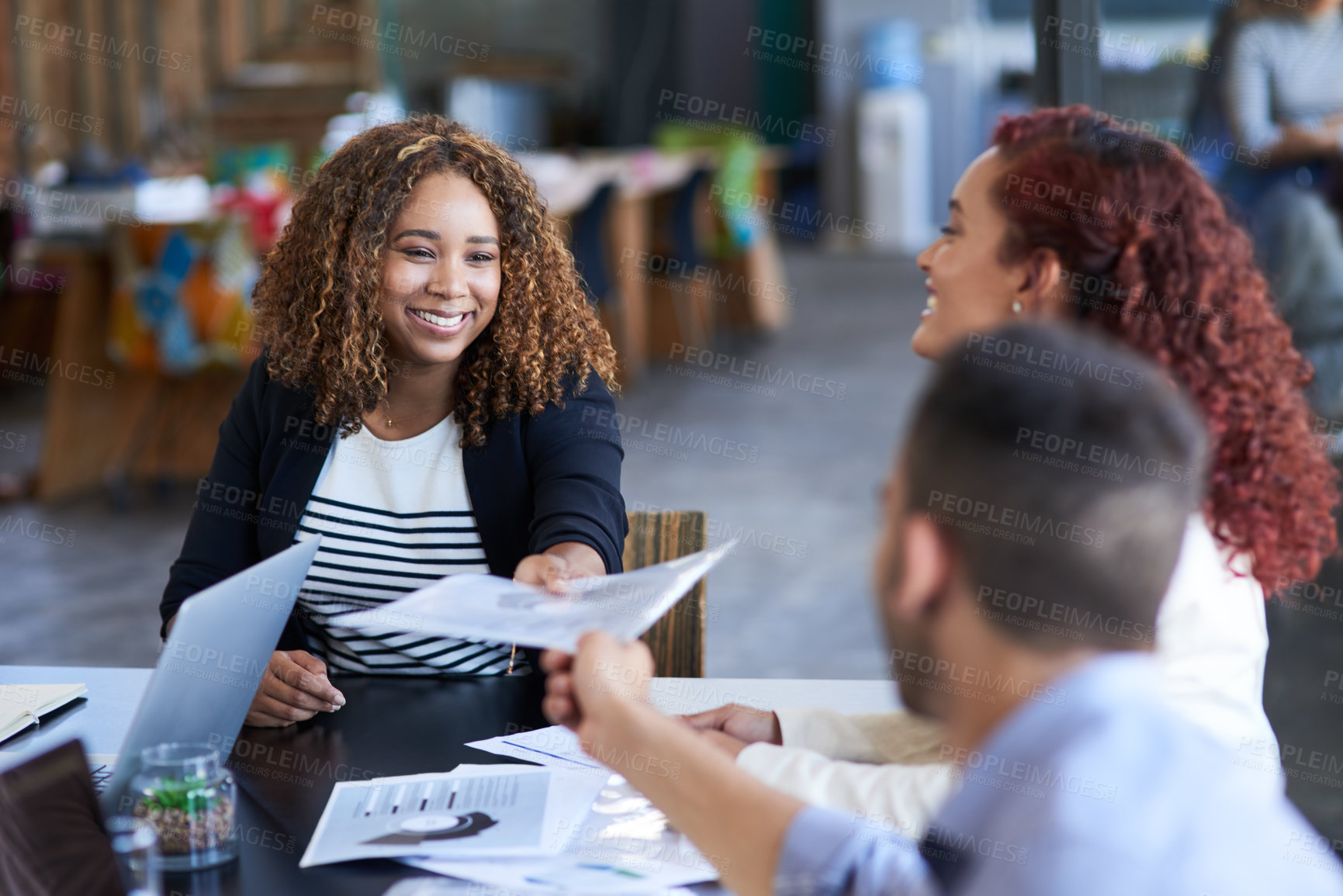 Buy stock photo Cropped shot of an attractive young businesswoman handing over some paperwork to a male colleague during a meeting in the boardroom