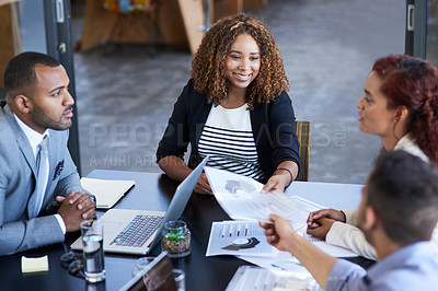 Buy stock photo High angle shot of an attractive young businesswoman handing over some paperwork to a male colleague during a meeting in the boardroom