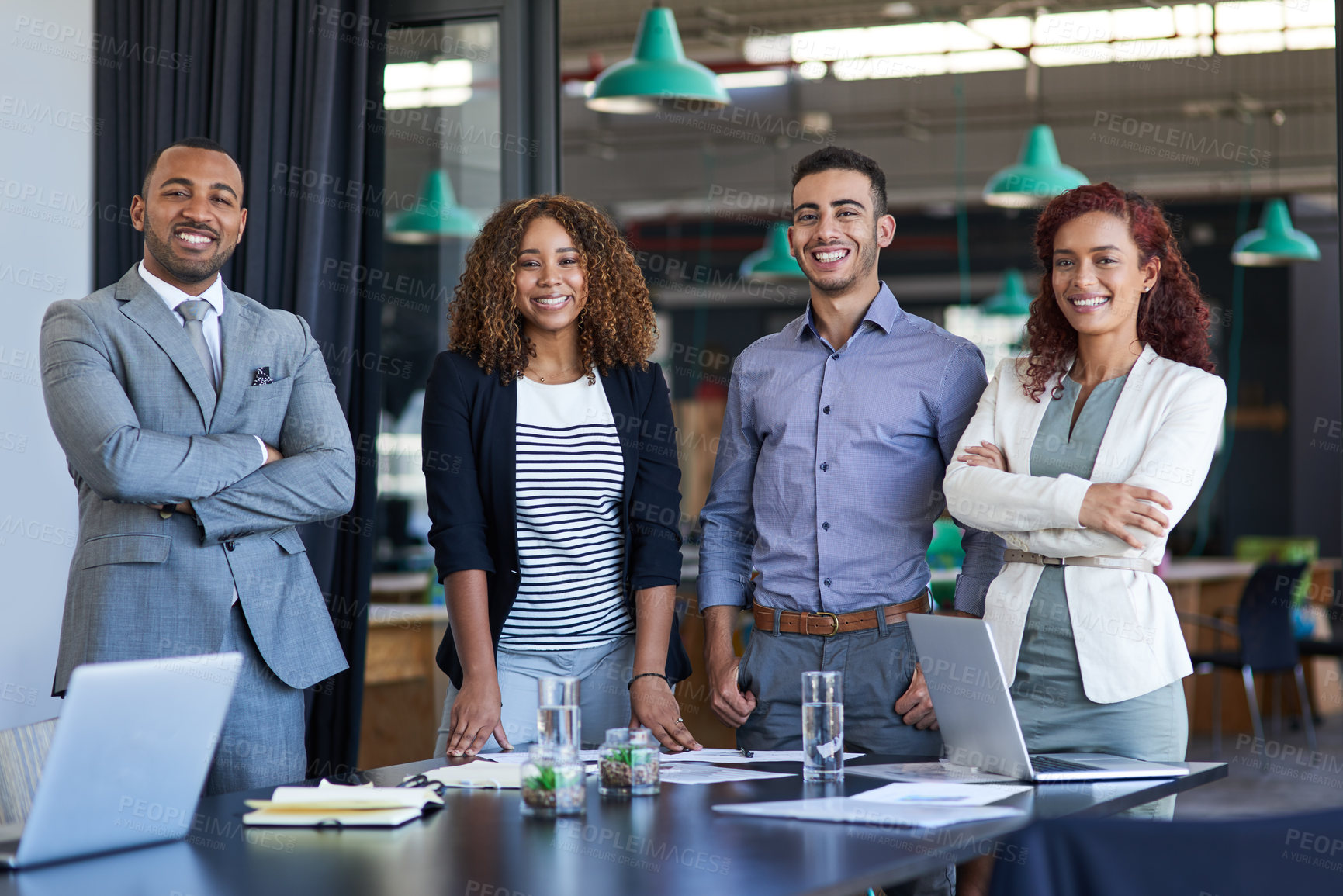 Buy stock photo Cropped portrait of a group of young businesspeople standing in the boardroom