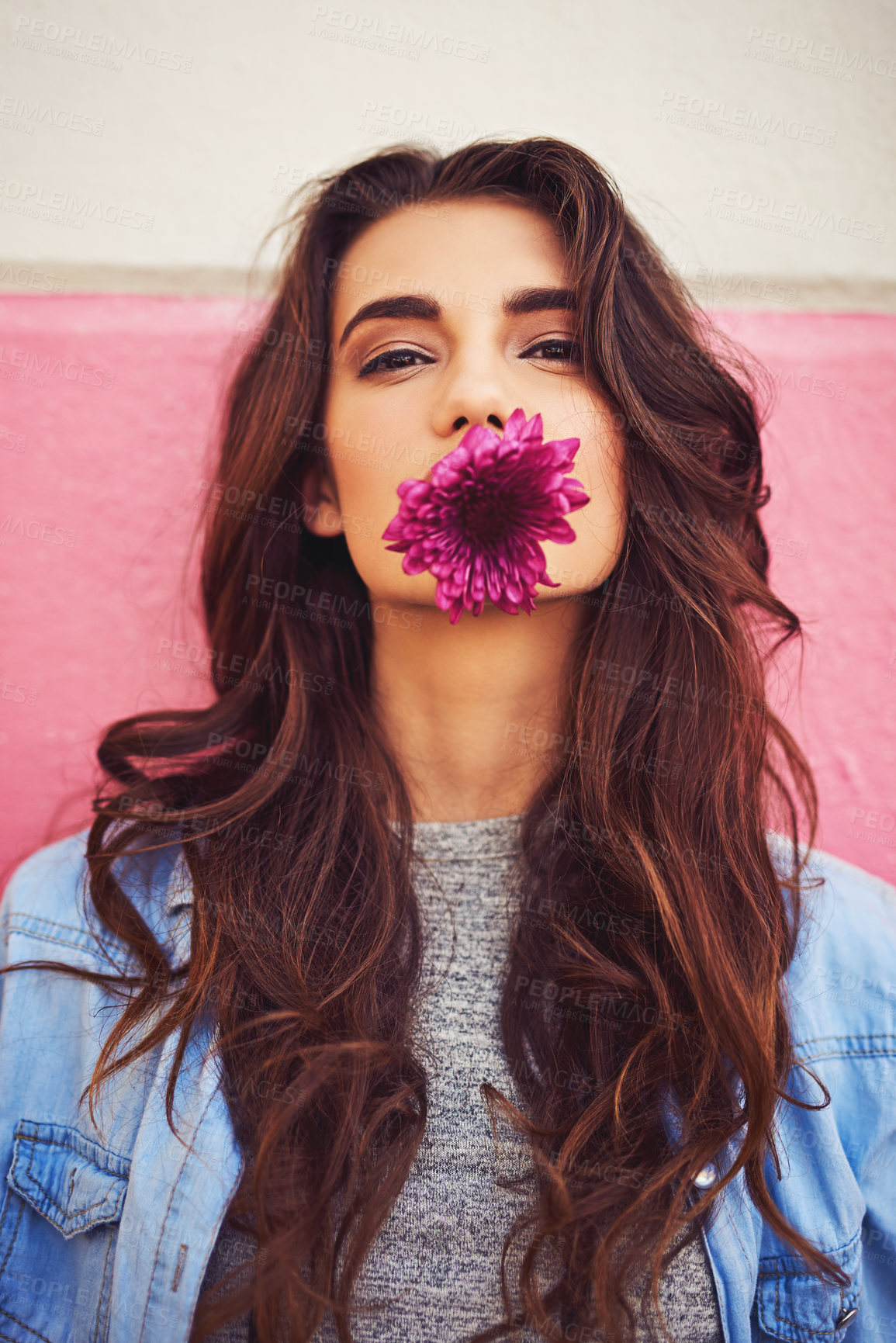 Buy stock photo Makeup, flower and portrait of woman by wall for cosmetics,  person and confidence. Gen z, girl and purple plant in street for aesthetic, glow and wellness or pride for eco friendly fashion in city 