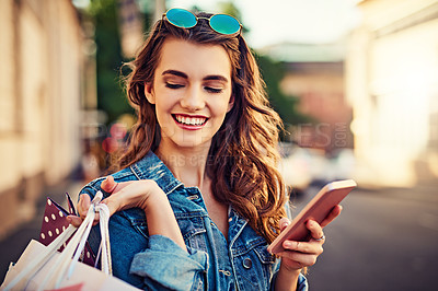 Buy stock photo Cropped shot of a beautiful young woman on a shopping spree in the city