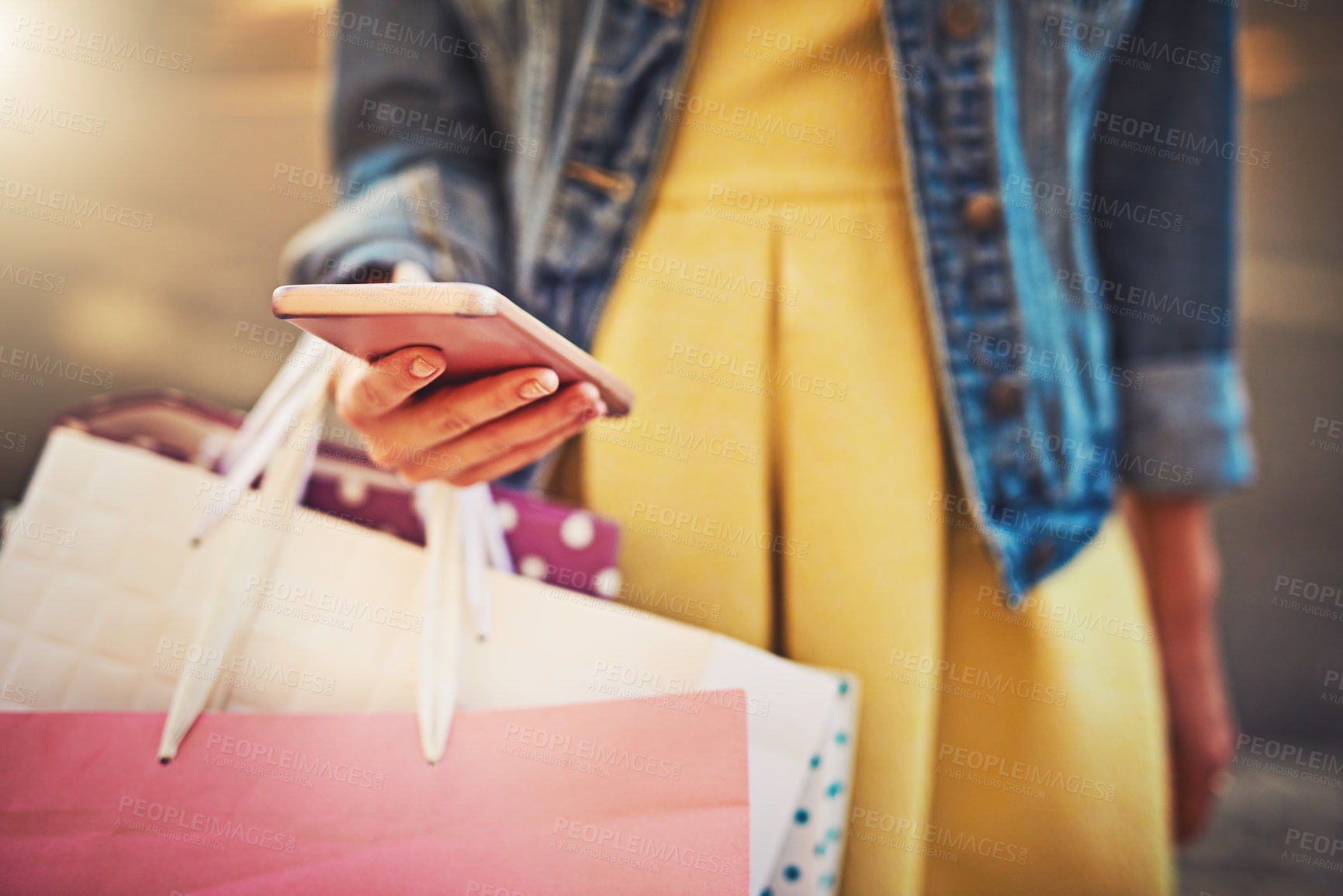 Buy stock photo Cropped shot of an unrecognizable woman on a shopping spree in the city