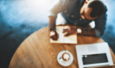 Buy stock photo Defocused shot of a young man working in a cafe