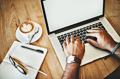 Buy stock photo High angle shot of an unrecognizable man working on a laptop in a cafe