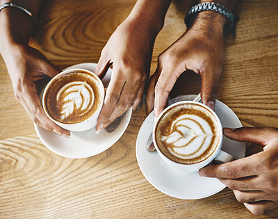 Buy stock photo High angle shot of an unrecognizable young couple sitting in a coffee shop