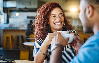 Buy stock photo Cropped shot of an attractive young woman spending time with her boyfriend in a coffee shop