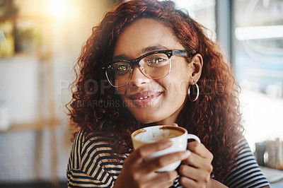 Buy stock photo Portrait of an attractive young woman enjoying a cup of coffee in a cafe