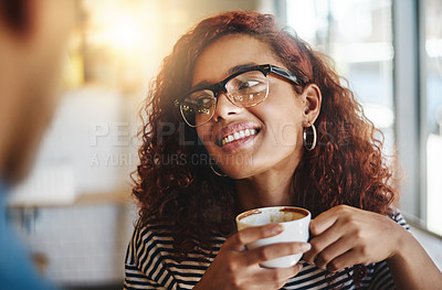 Buy stock photo Shot of a young woman having coffee with her boyfriend in a cafe