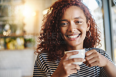 Buy stock photo Portrait of an attractive young woman enjoying a cup of coffee in a cafe