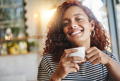 Buy stock photo Portrait of an attractive young woman enjoying a cup of coffee in a cafe