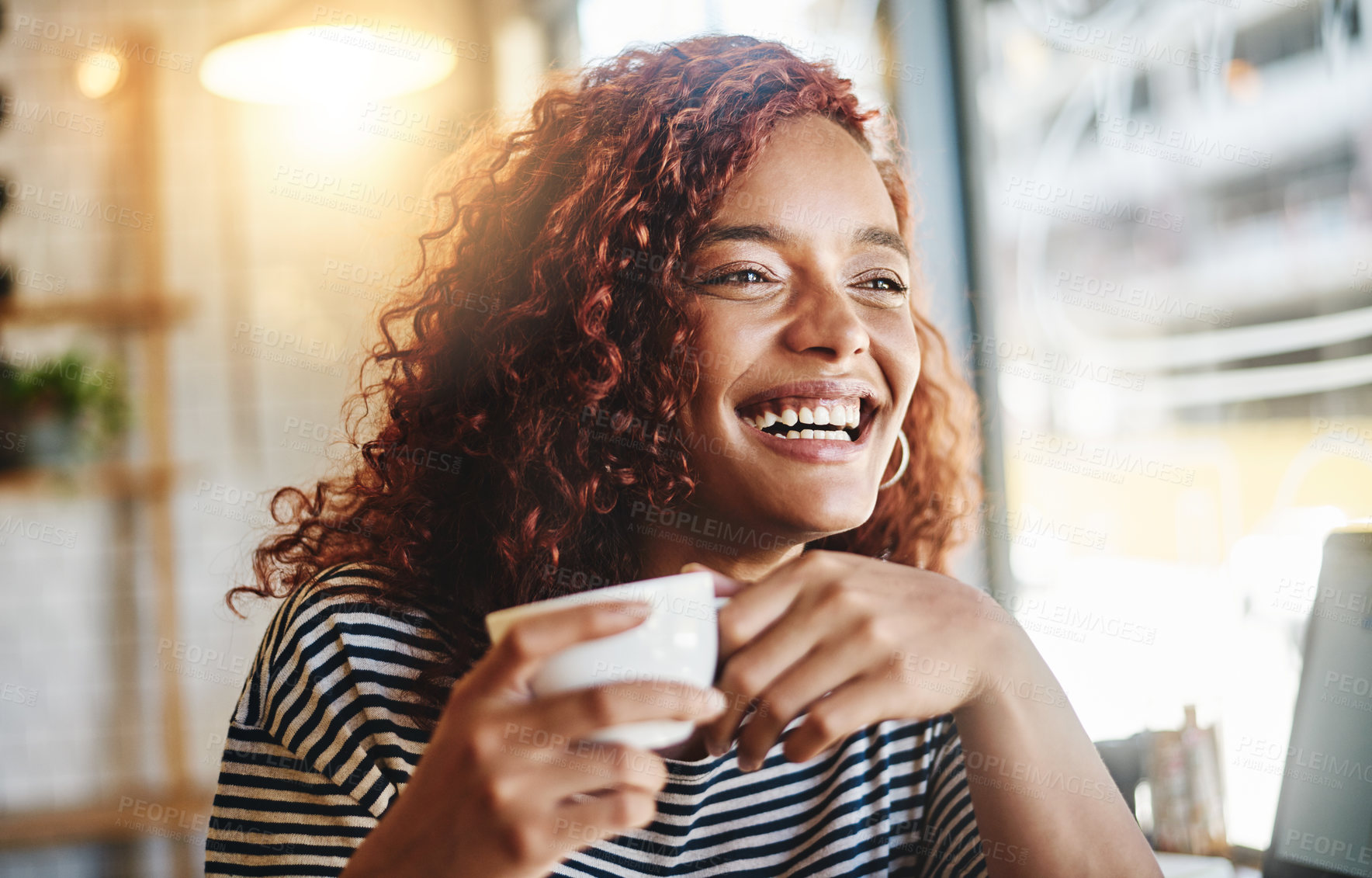 Buy stock photo Shot of an attractive young woman enjoying a cup of coffee in a cafe
