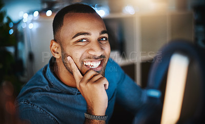 Buy stock photo Portrait of a young businessman using a computer during a late night at work in a modern office