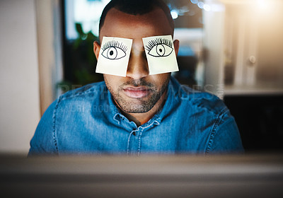 Buy stock photo Shot of a tired young businessman working late in an office with sticky notes covering his eyes