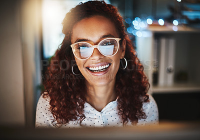 Buy stock photo Portrait of a young businesswoman using a computer during a late night at work in a modern office