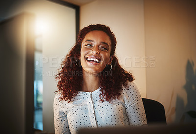 Buy stock photo Shot of a young businesswoman using a computer during a late night at work in a modern office