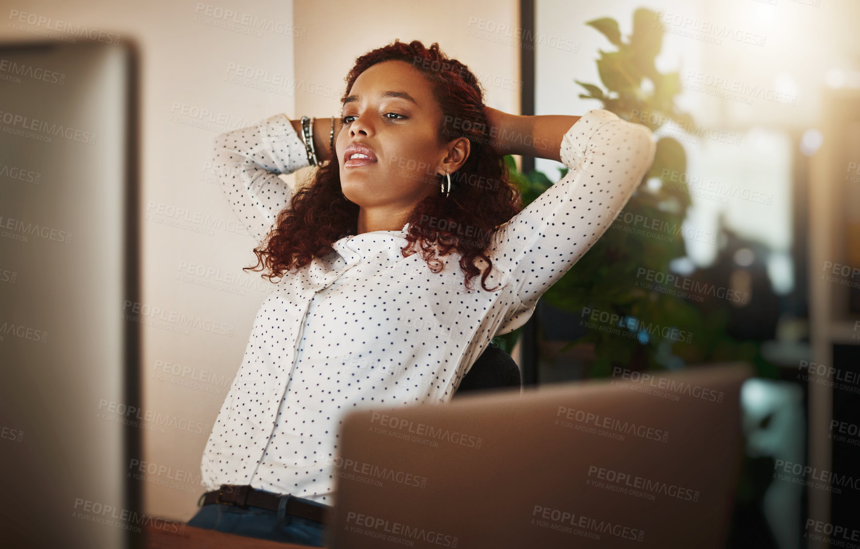 Buy stock photo Shot of a young businesswoman taking a break at her desk in a modern office