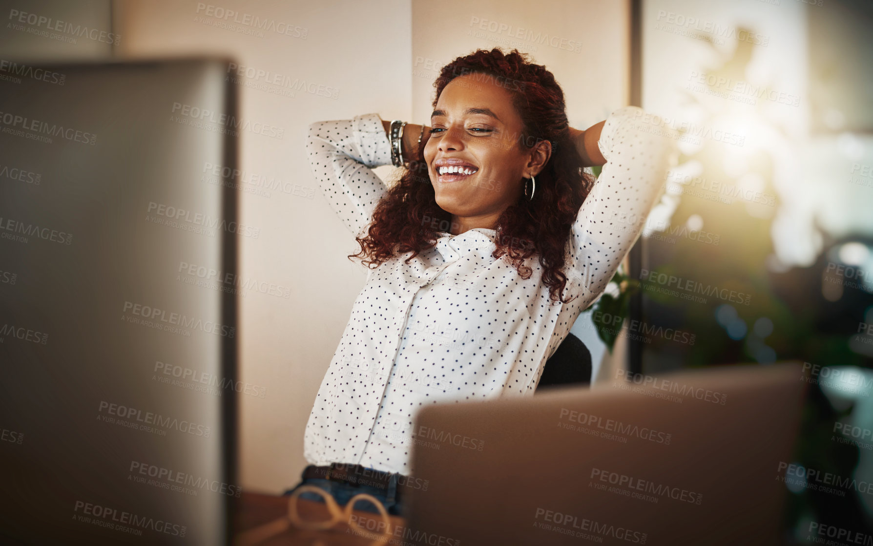 Buy stock photo Shot of a young businesswoman taking a break at her desk in a modern office