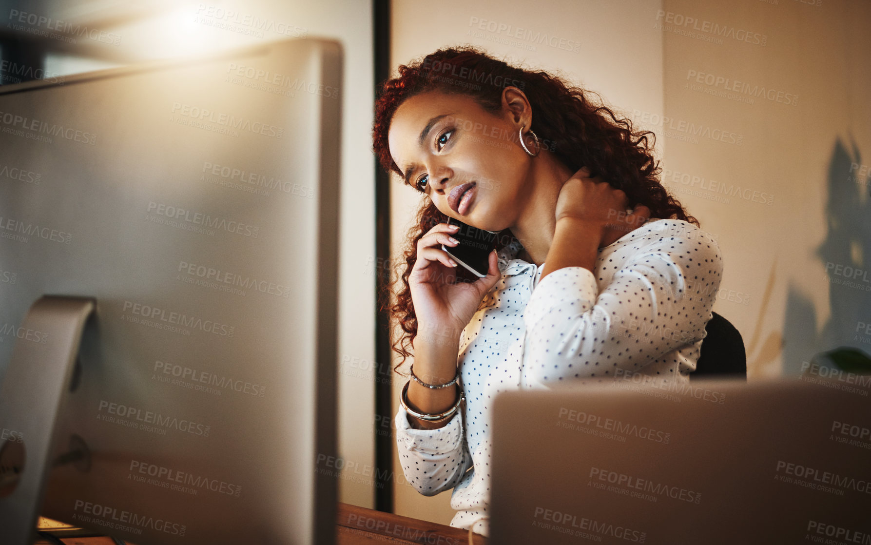 Buy stock photo Shot of a young businesswoman experiencing tension during a late night at work