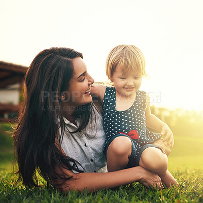 Buy stock photo Cropped shot of a young mother and her adorable daughter spending the day in the backyard