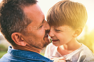 Buy stock photo Shot of a father bonding with his adorable little son outdoors
