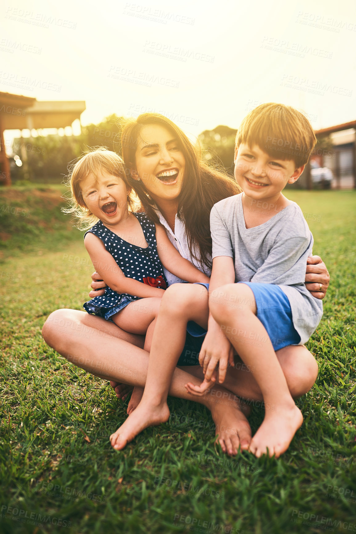 Buy stock photo Mother, happy kids or hug playing on grass for fun bonding in summer outside a house in nature. Funny mom hugging playful children on garden playground outdoors with happiness of family together