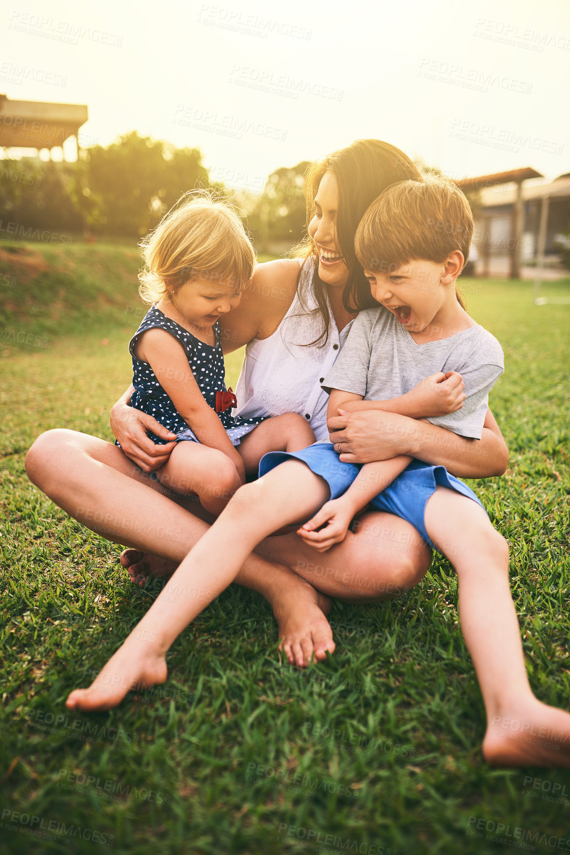 Buy stock photo Mother, happy children or hug playing on grass for fun bonding in summer outside a house in nature. Funny mom hugging playful kids siblings on garden playground with happiness of family together