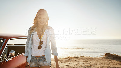 Buy stock photo Shot of a beautiful young woman going on a road trip to the beach