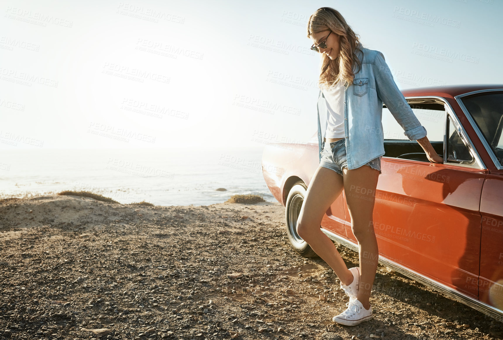 Buy stock photo Shot of a beautiful young woman going on a road trip to the beach