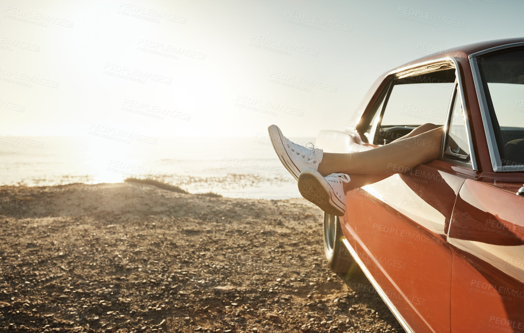 Buy stock photo Car window, legs and road trip with person at beach to relax on holiday for travel or summer vacation. Nature, sky and view with tourist outdoor on coast by ocean or sea for adventure or journey