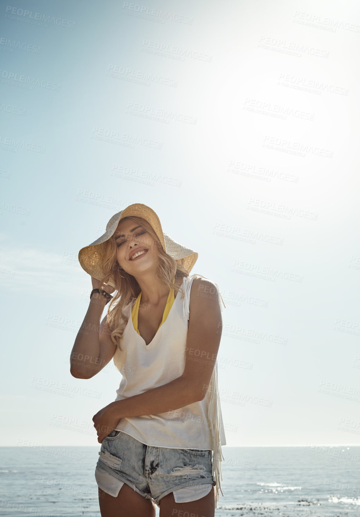 Buy stock photo Portrait of an attractive young woman enjoying her day on the beach