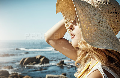 Buy stock photo Shot of an attractive young woman spending a summer's day on the beach