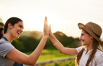 Buy stock photo Cropped shot of an attractive young woman high fiving while working on their family farm