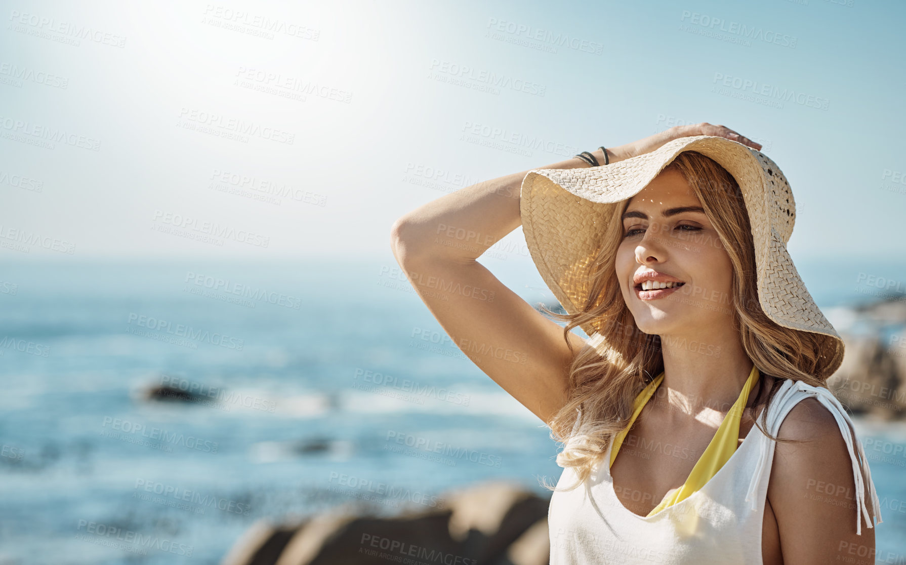 Buy stock photo Shot of an attractive young woman enjoying her day on the beach