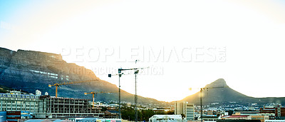 Buy stock photo Shot of the city of Cape Town with Table mountain and Lion's Head in the background during sundown