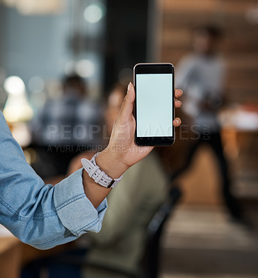 Buy stock photo Closeup shot of an unrecognizable businesswoman holding up a cellphone with a blank screen in an office