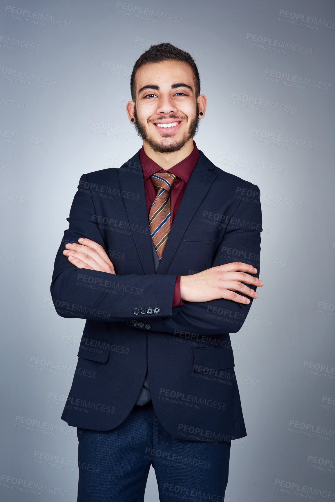 Buy stock photo Studio shot of a handsome young businessman posing against a grey background