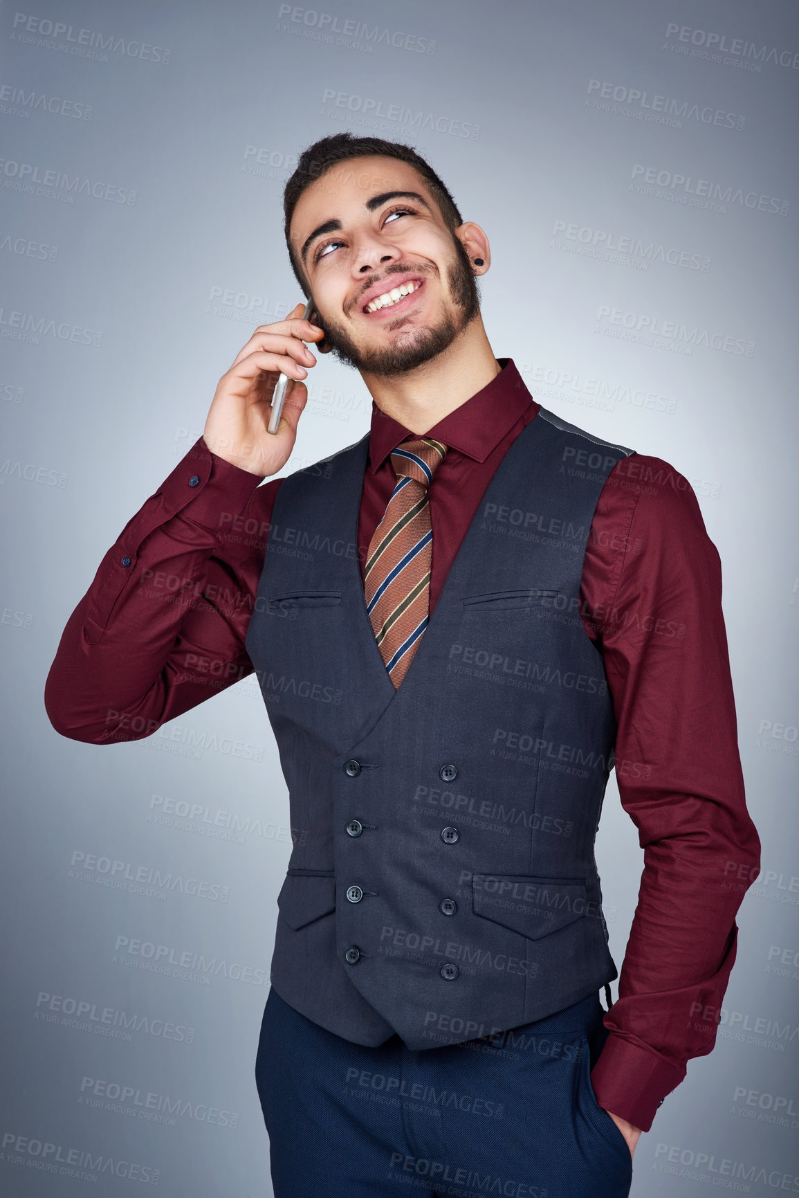 Buy stock photo Studio shot of a handsome young businessman on a call against a grey background