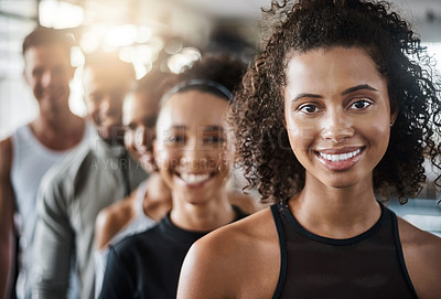 Buy stock photo Shot of a group of young people standing together in a line at the gym